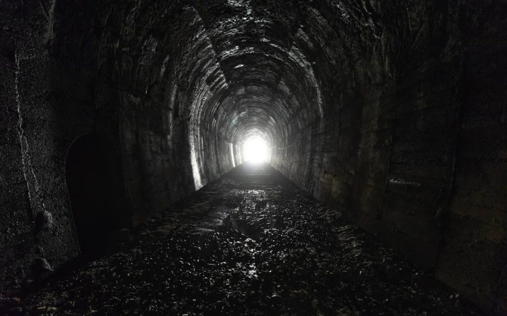 Długi tunel zakończony światłem – symbol wyjścia z podziemnych korytarzy na powierzchnię