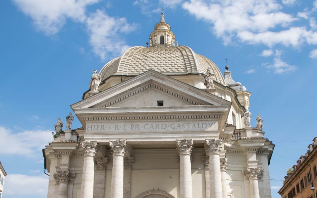 Charakterystyczna kopuła i koryncki portyk rzymskiego kościoła Santa Maria dei Miracoli w pełnym słońcu