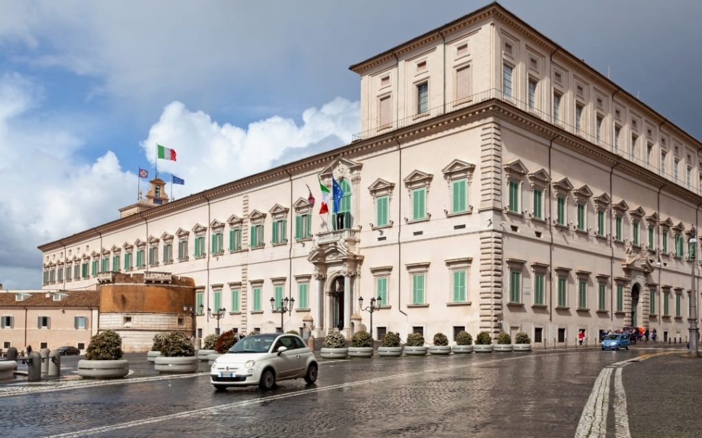 Fasada Pałacu Kwirynalskiego w Rzymie przy placu Piazza del Quirinale z flagami