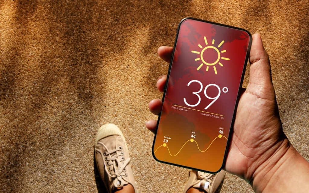Osoba trzymająca telefon z widoczną temperaturą na ekranie
