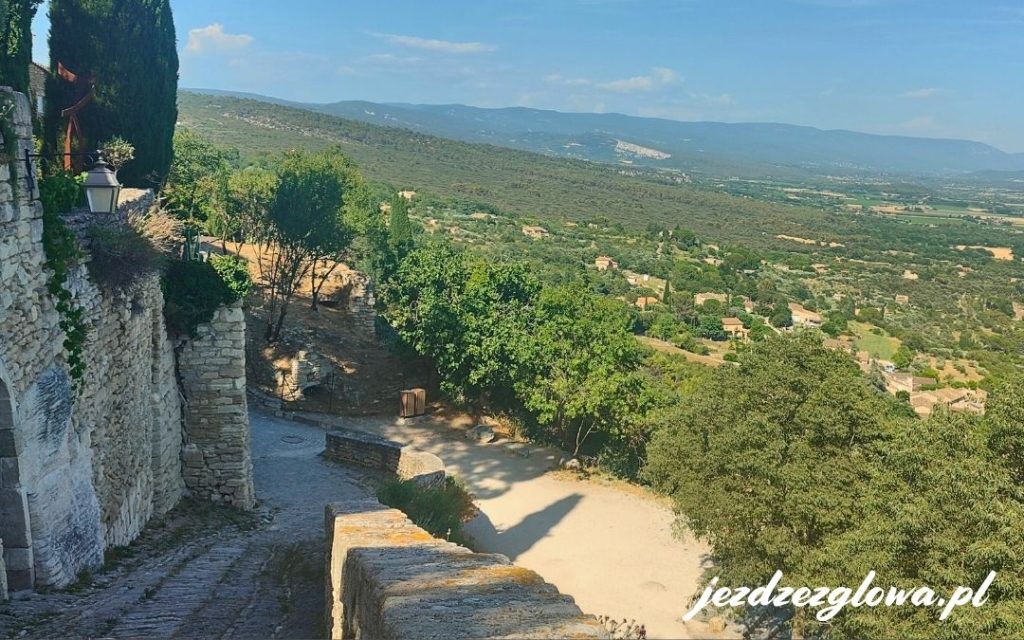 Gordes – widok z murów wioski na dolinę Luberon, kamienna uliczka i panorama Prowansji